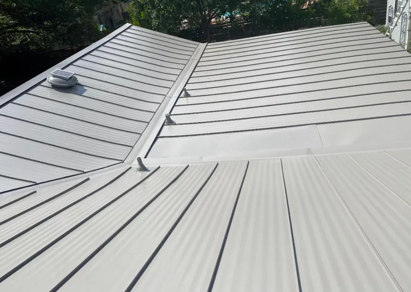 Solar attic fan installed on a metal roof for Roof Ventilation in Apex
